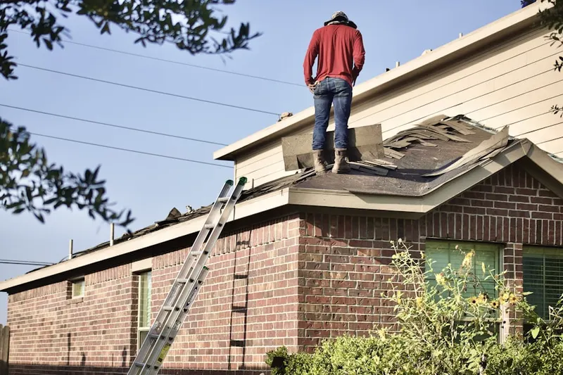 Professional roofer working on a residential roof in Pohick Hills